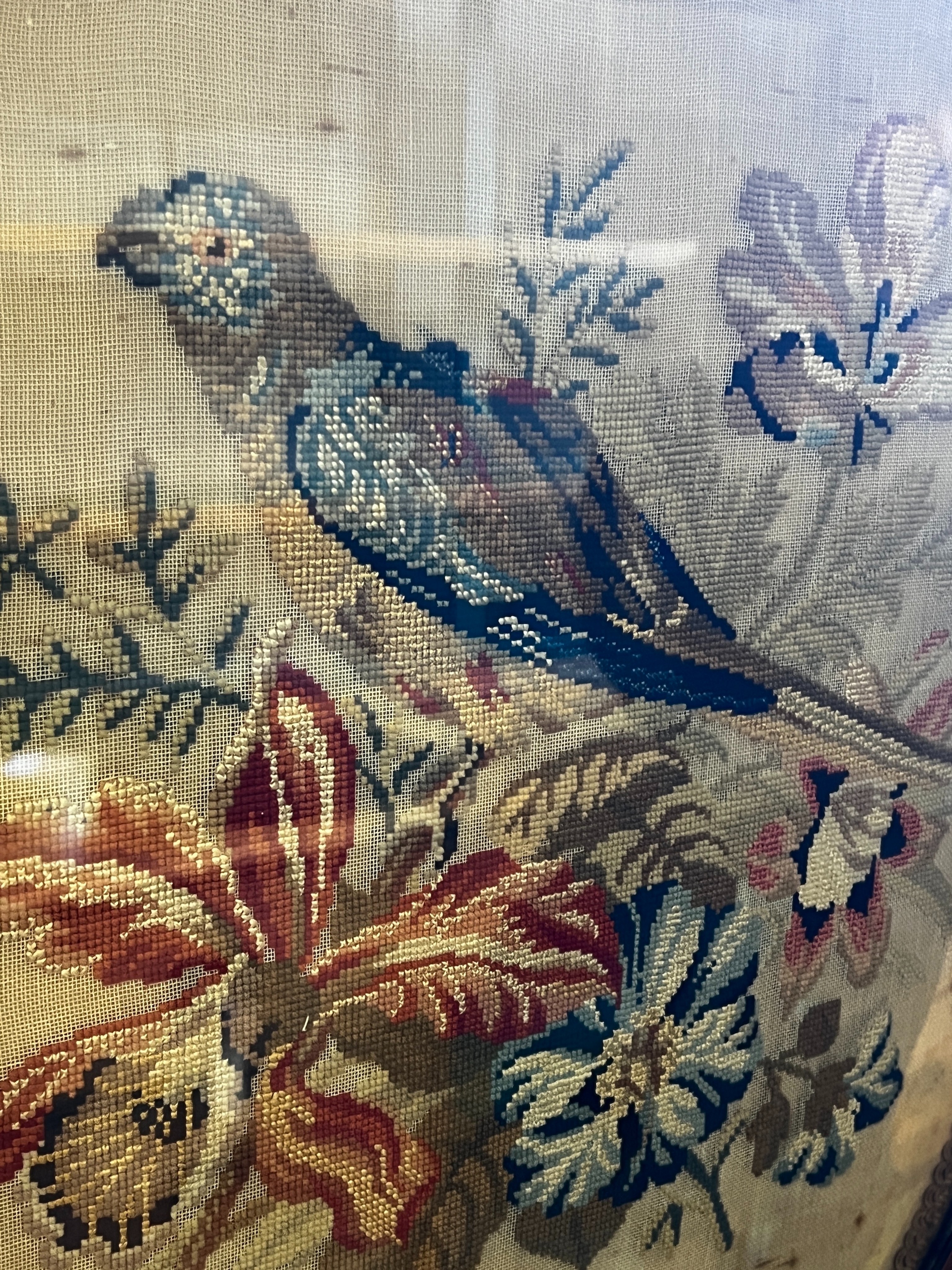 A Victorian carved walnut fire screen with needlework parrot banner, width 56cm, height 99cm *Please note the sale commences at 9am.